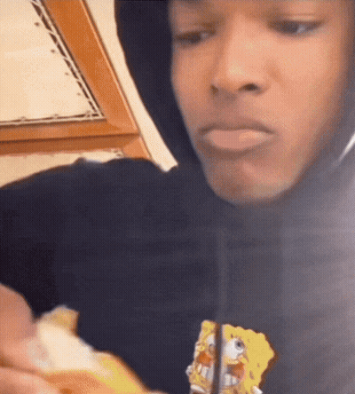 A Man Wearing A Black Hoodie With Spongebob On It GIF