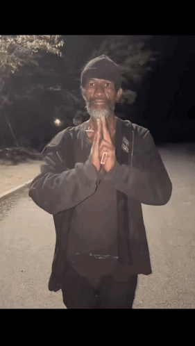 A Man Wearing A Black Jacket And A Hat With The Letter O On It GIF