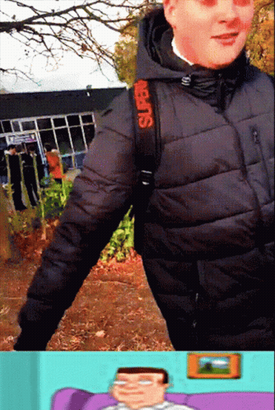 A Man Wearing A Black Jacket And A Red Strap That Says Super On It GIF