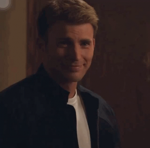 A Man Wearing A Black Jacket And A White Shirt Is Smiling GIF