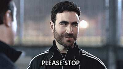 A Man Wearing A Black Jacket Says Please Stop In Front Of Another Man GIF
