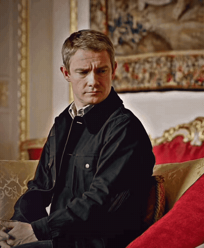 A Man Wearing A Black Jacket Sits On A Couch GIF