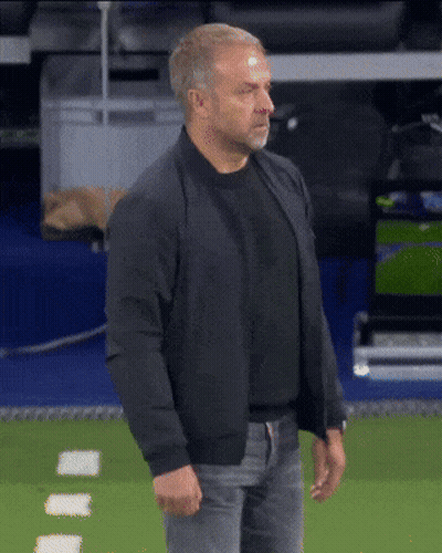 A Man Wearing A Black Jacket Stands On A Field GIF