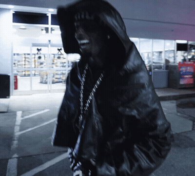 A Man Wearing A Black Jacket With A Hood And A Hat That Says ' A.i.f. ' On It GIF