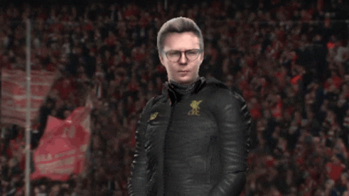 A Man Wearing A Black Jacket With A New Balance Logo On The Front GIF