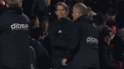 A Man Wearing A Black Jacket With The Word Adidas On It GIF