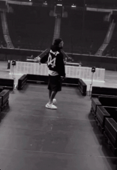 A Man Wearing A Black Jersey With The Number 04 On The Back GIF