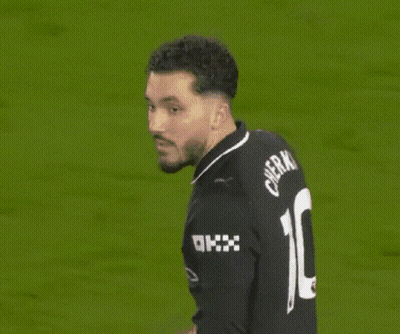 A Man Wearing A Black Jersey With The Number 10 On The Back GIF