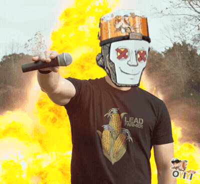 A Man Wearing A Black Lead Farmer Shirt Holds A Microphone GIF