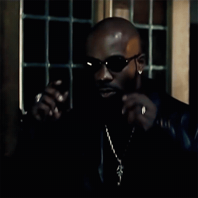 A Man Wearing A Black Leather Jacket And A Gold Chain GIF