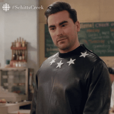 A Man Wearing A Black Leather Jacket With White Stars On The Sleeves GIF