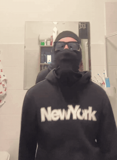A Man Wearing A Black New York Sweatshirt GIF