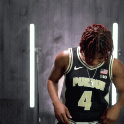 A Man Wearing A Black Purdue Jersey With The Number 4 GIF