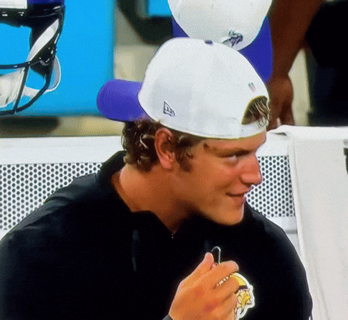 A Man Wearing A Black Shirt And A White Hat With The Letter A On It GIF