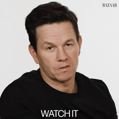 A Man Wearing A Black Shirt Says Watch It In Front Of A White Background GIF