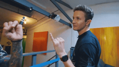 A Man Wearing A Black Shirt That Has The Word Joker On The Sleeve GIF