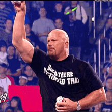 A Man Wearing A Black Shirt That Says " Been There Destroyed That " Raises His Fist In The Air GIF