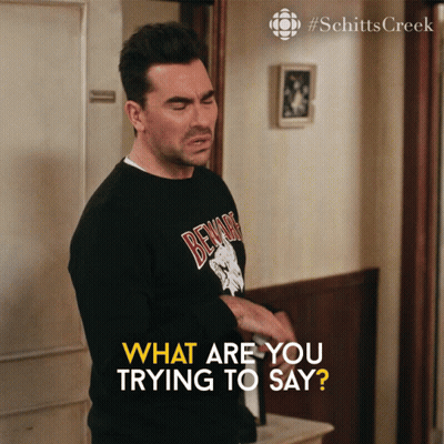 A Man Wearing A Black Shirt That Says Beware Is Asking What Are You Trying To Say GIF