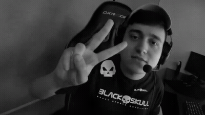 A Man Wearing A Black Shirt That Says Black Skull Giving A Peace Sign GIF