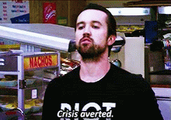 A Man Wearing A Black Shirt That Says Crisis Averted GIF