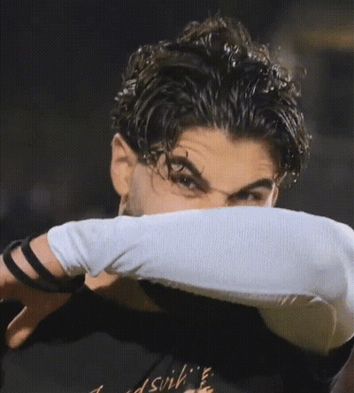 A Man Wearing A Black Shirt That Says ' Dsvih ' On It GIF