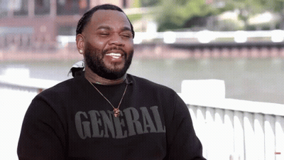 A Man Wearing A Black Shirt That Says General GIF