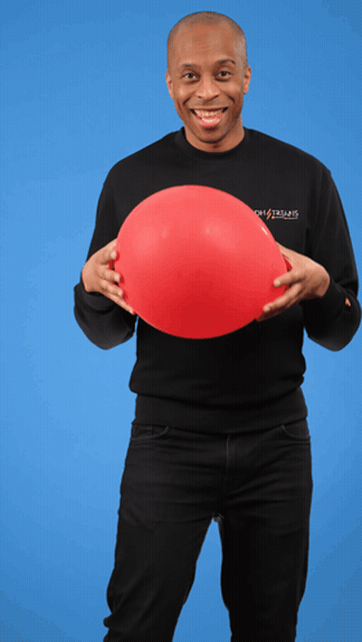 A Man Wearing A Black Shirt That Says Ghostbusters Holds A Red Balloon In His Hands GIF