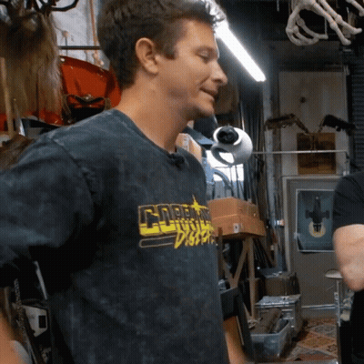 A Man Wearing A Black Shirt That Says Gnarly Disco On It GIF