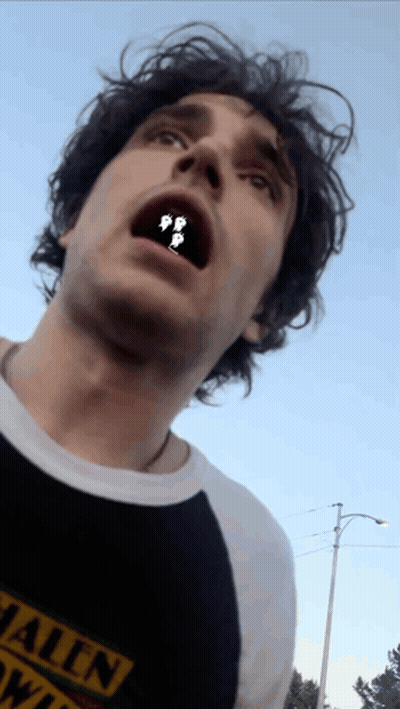 A Man Wearing A Black Shirt That Says ' Hawaii ' On It GIF