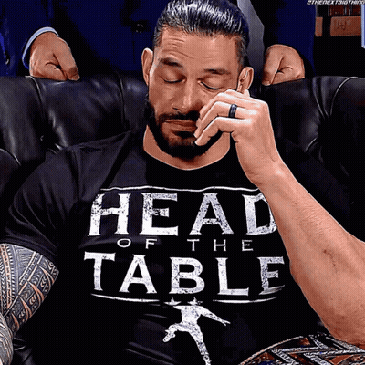 A Man Wearing A Black Shirt That Says Head Of The Table On It GIF