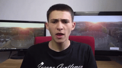A Man Wearing A Black Shirt That Says ' Insane Gentlemen ' GIF