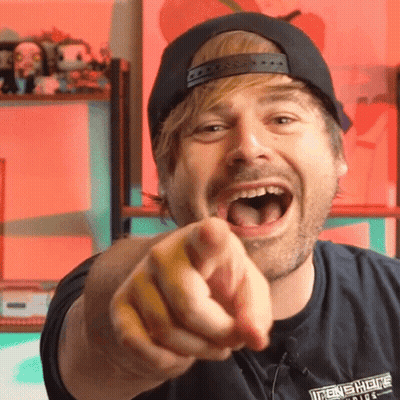 A Man Wearing A Black Shirt That Says Iron Shields Is Pointing His Finger GIF