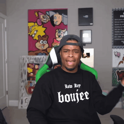 A Man Wearing A Black Shirt That Says Low Key Boujee On It GIF