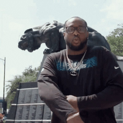 A Man Wearing A Black Shirt That Says Panthers On It GIF