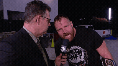 A Man Wearing A Black Shirt That Says Tnt On It GIF