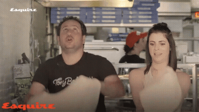 A Man Wearing A Black Shirt That Says " Tony B " Is Standing Next To A Woman GIF