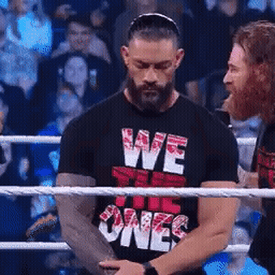 A Man Wearing A Black Shirt That Says We The Ones Is Standing In A Boxing Ring . GIF