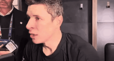 A Man Wearing A Black Shirt With A Lanyard Around His Neck That Says Canadian Airlines On It GIF