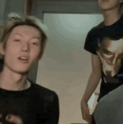A Man Wearing A Black Shirt With A Picture Of A Man On It GIF