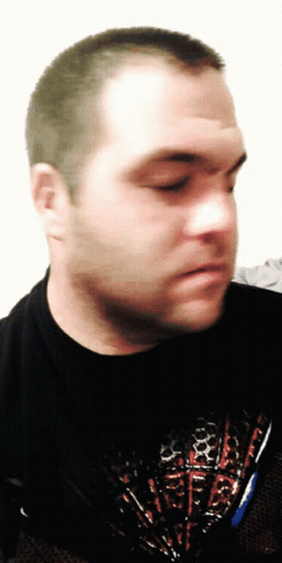 A Man Wearing A Black Shirt With A Red White And Blue Design GIF