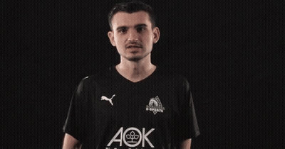 A Man Wearing A Black Shirt With Aok Written On It GIF