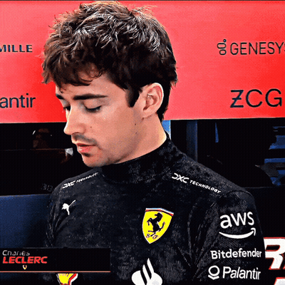 a man wearing a black shirt with ferrari on it