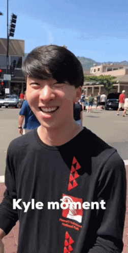 A Man Wearing A Black Shirt With Kyle Moment Written On It GIF