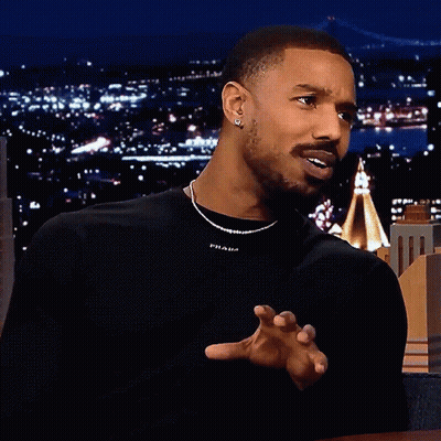 A Man Wearing A Black Shirt With Prada On It GIF