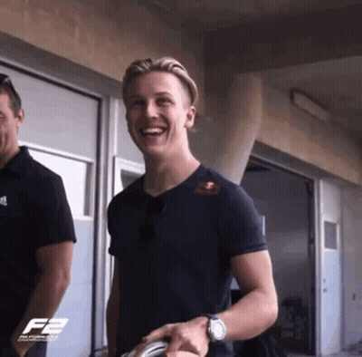A Man Wearing A Black Shirt With The Letter F2 On The Front GIF