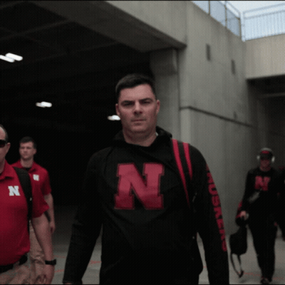 A Man Wearing A Black Shirt With The Letter N On The Front GIF
