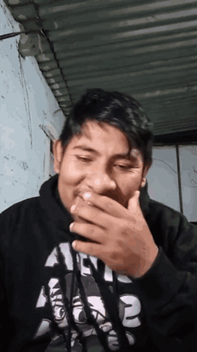A Man Wearing A Black Shirt With The Number 2 On It Covering His Mouth GIF