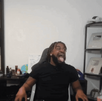 A Man Wearing A Black Shirt With The Word La On It Sticks His Tongue Out GIF