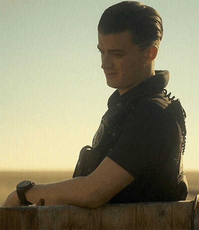 A Man Wearing A Black Shirt With The Word Police On The Back GIF