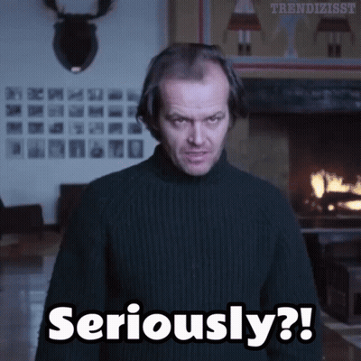 A Man Wearing A Black Sweater Says Seriously In Front Of A Fireplace GIF